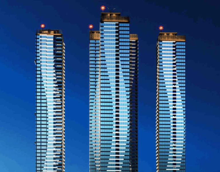 Luxury high-rise residential towers Candure Skyline in Nanakaramguda Hyderabad with modern glass facade and night lighting